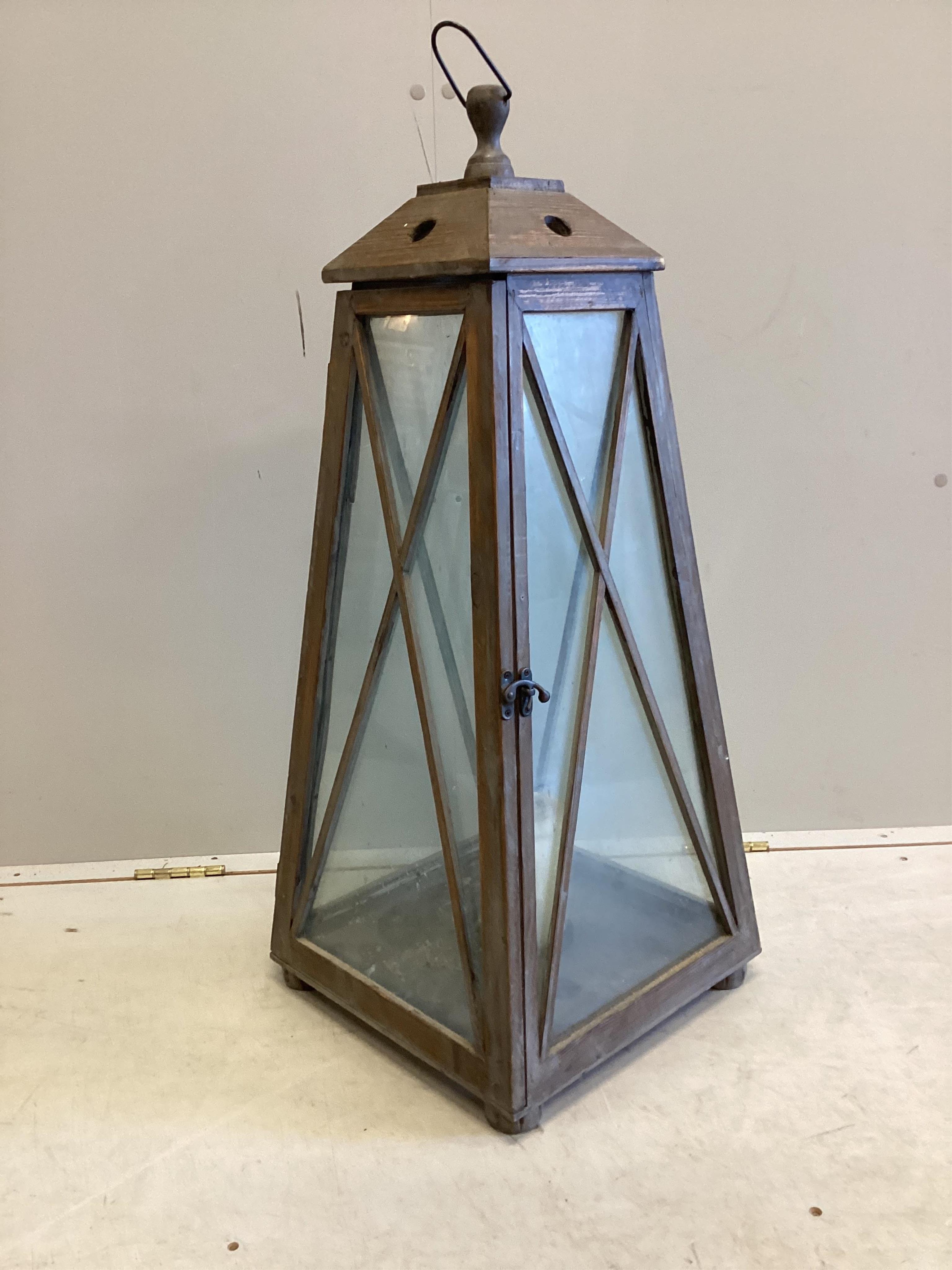 A large contemporary glazed pine interior candle lantern, height 86cm. Condition - good.